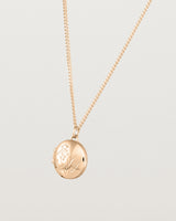 Angled view of the Golden Wattle Locket in rose gold.