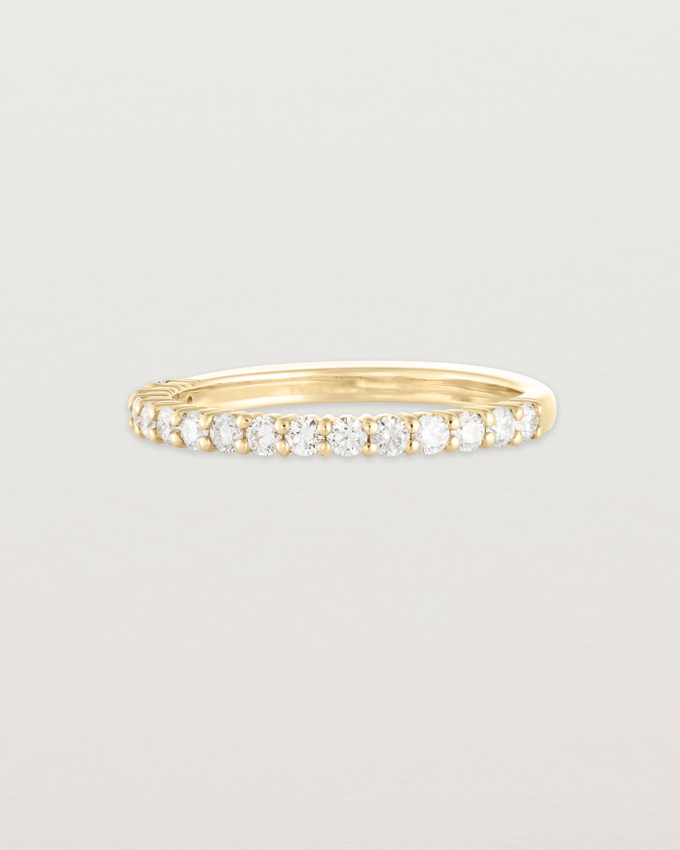 Angled view of the Demi Grace Ring | White Diamonds in yellow gold.