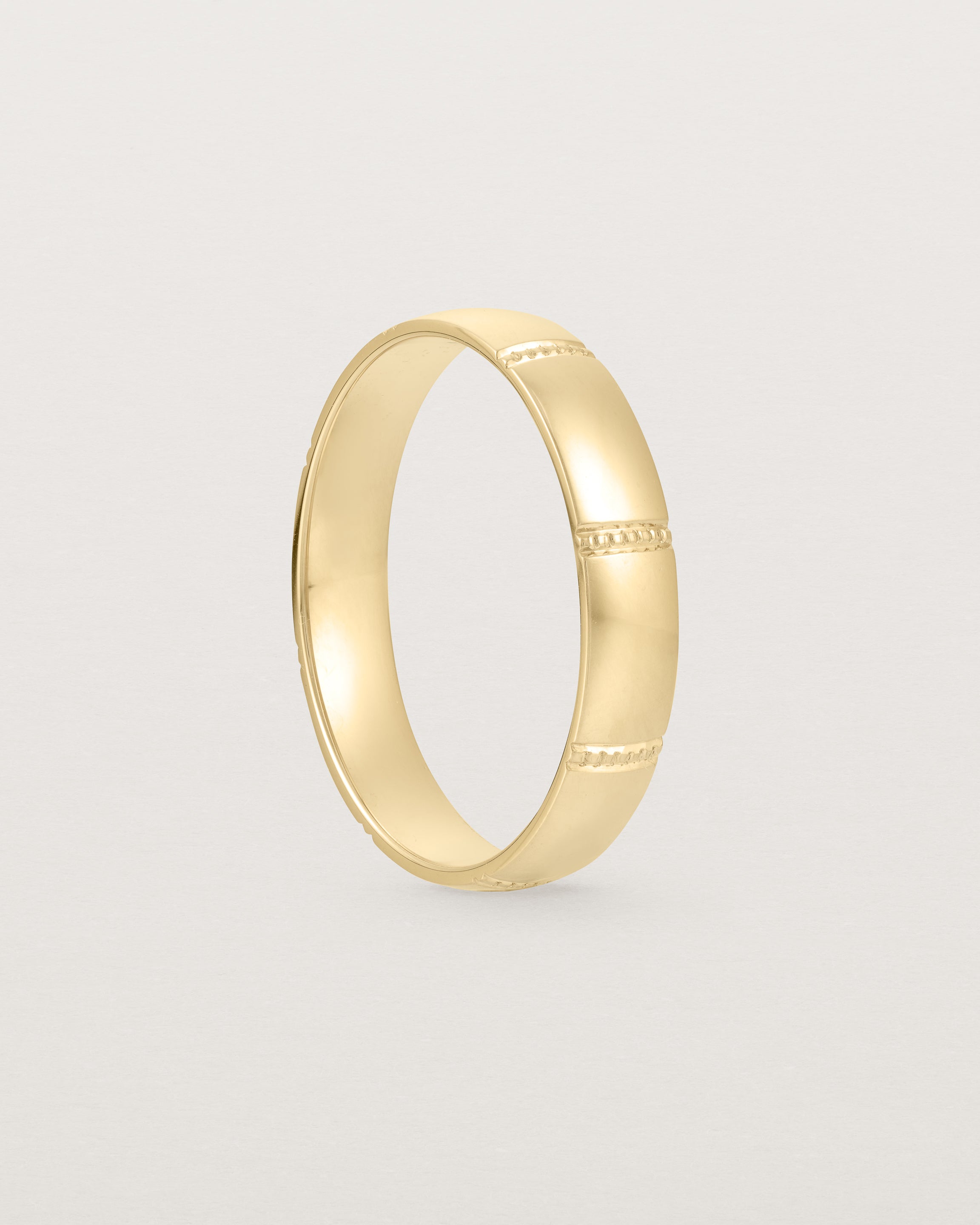 Standing view of the Grain Wedding Ring | 4mm | Yellow Gold.