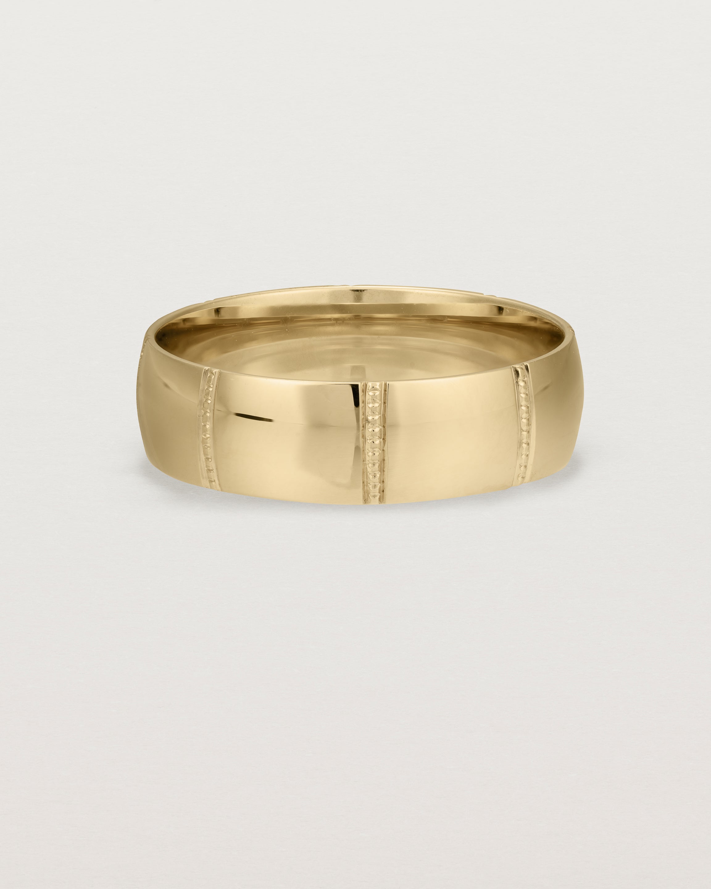 Front view of the Grain Wedding Ring | 6mm | Yellow Gold.