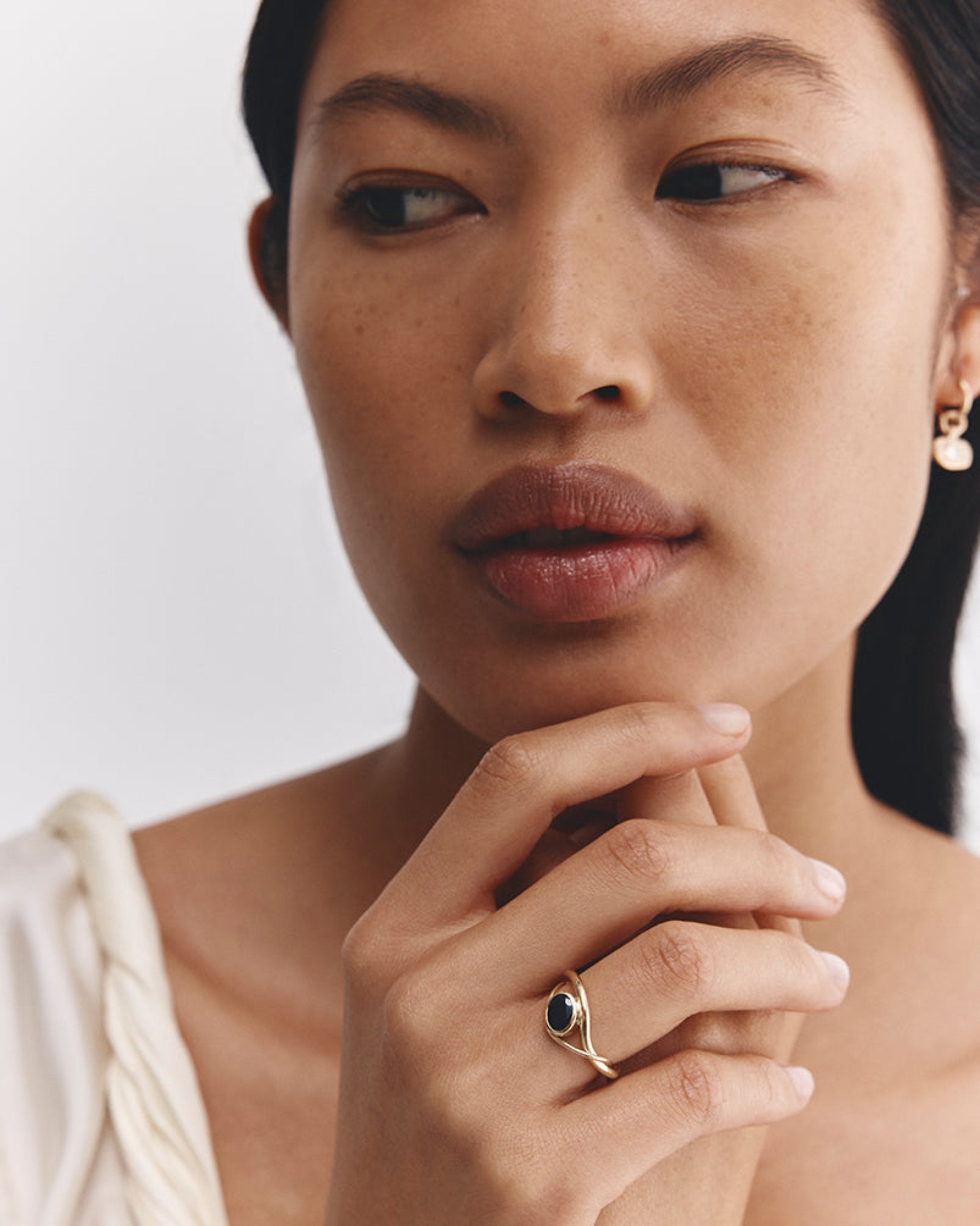 Model wears Isha Oval Ring 
 with Australian Sapphire in yellow gold.