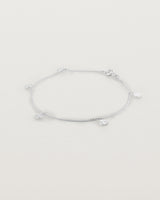 A silver chain bracelet with five circle charms
