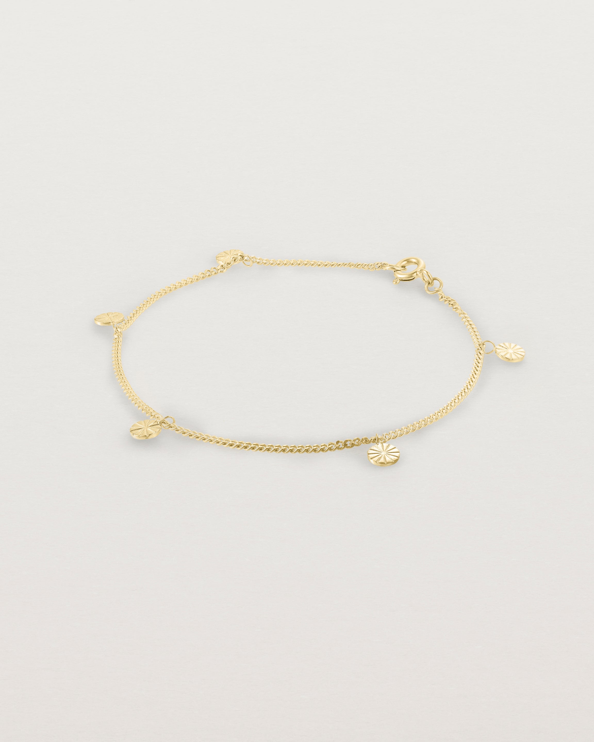 A yellow gold chain bracelet with five circle charms