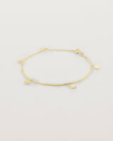 A yellow gold chain bracelet with five circle charms