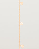 A rose gold chain bracelet with five circle charms