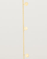 A yellow gold chain bracelet with five circle charms