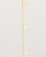 A yellow gold chain bracelet with five circle charms