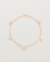 A rose gold chain bracelet with five circle charms