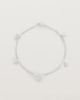 A silver chain bracelet with five circle charms