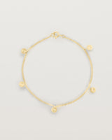 A yellow gold chain bracelet with five circle charms