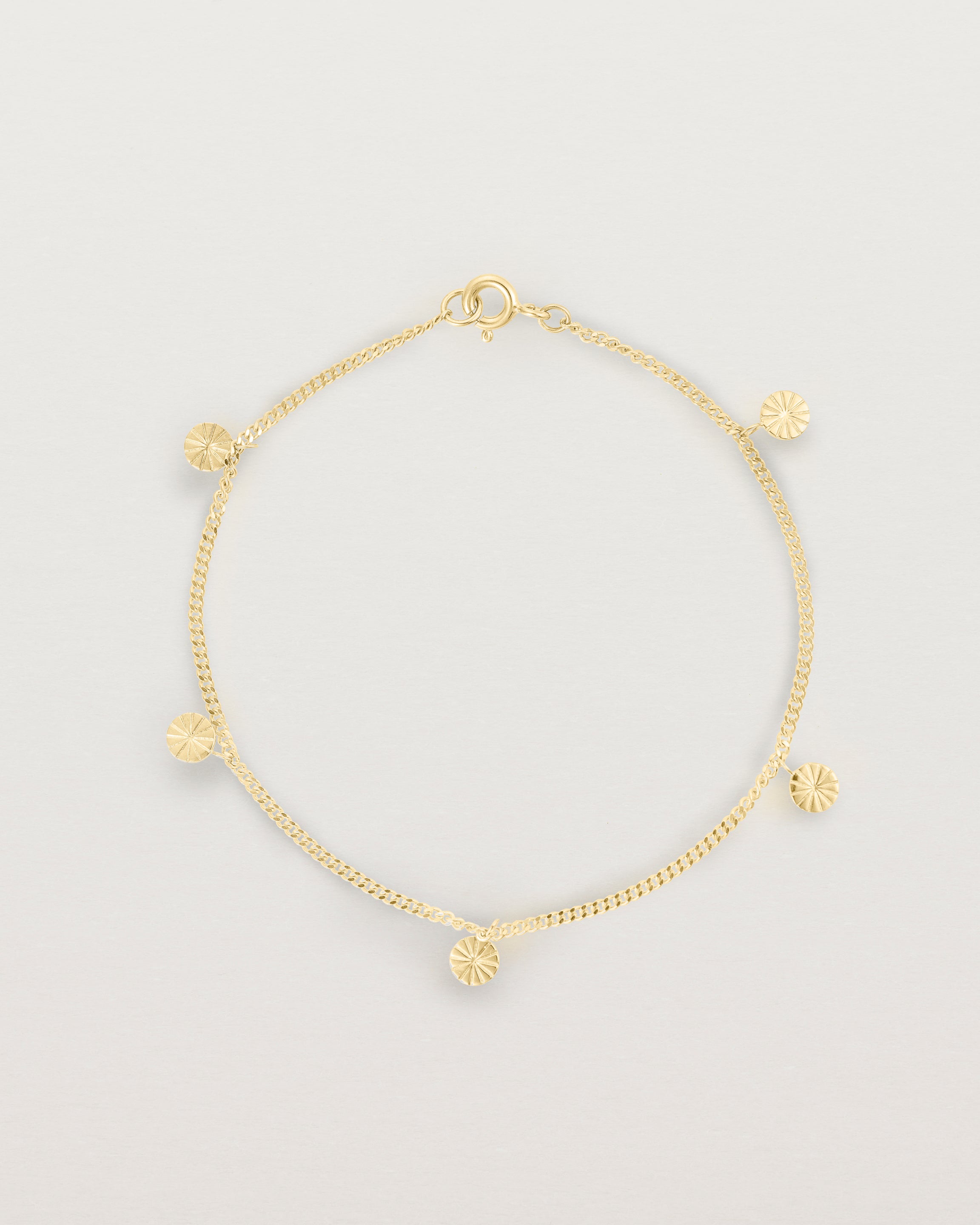 A yellow gold chain bracelet with five circle charms