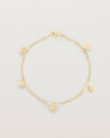 A yellow gold chain bracelet with five circle charms