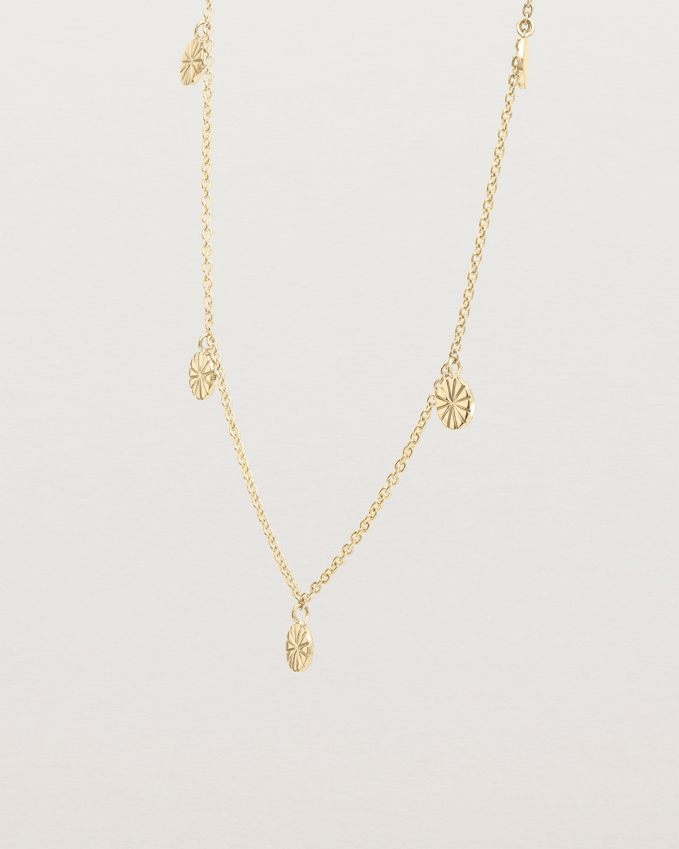 Angled view of the Jia Charm Necklace | Yellow Gold.
