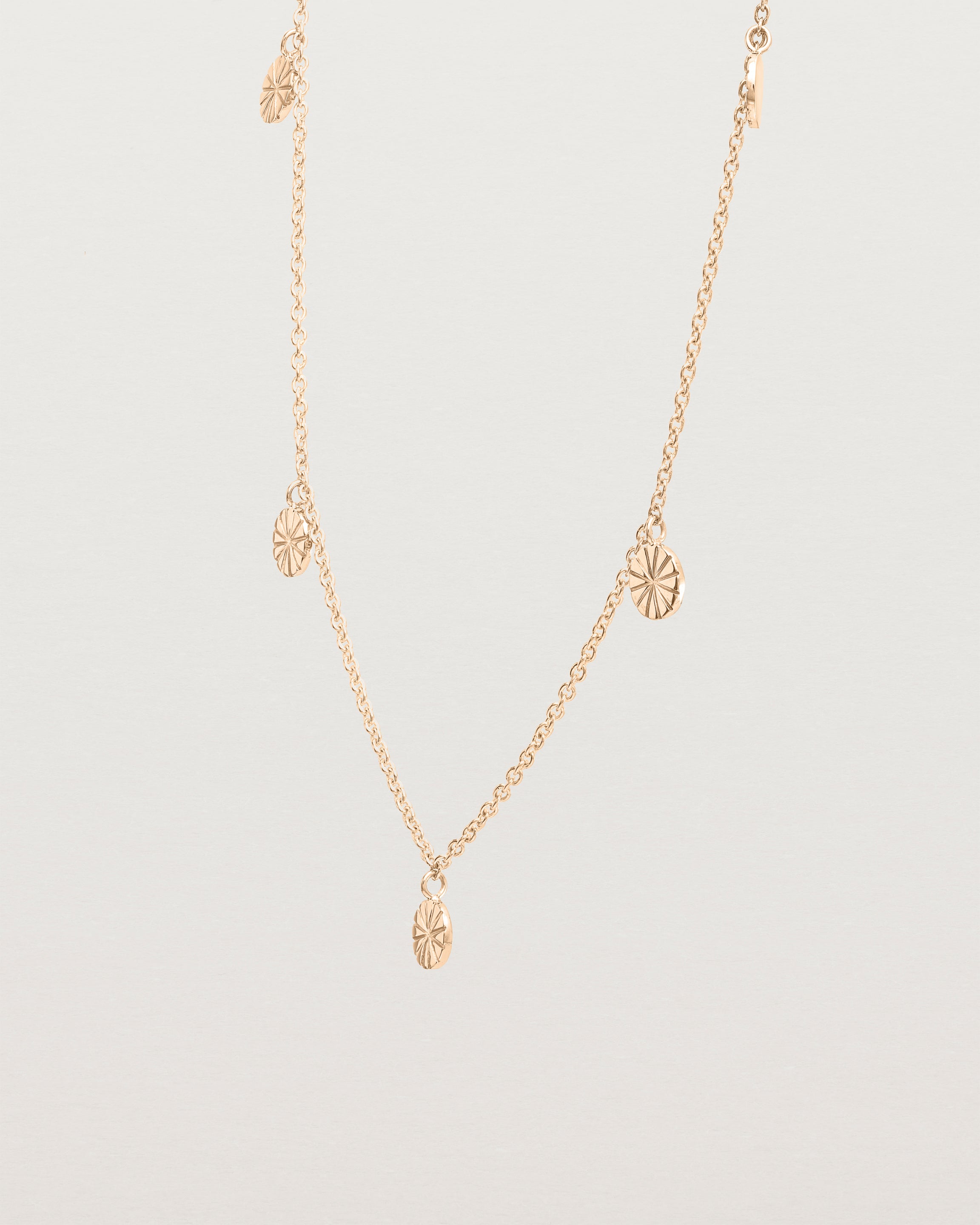 Angled view of the Jia Charm Necklace | Rose Gold.