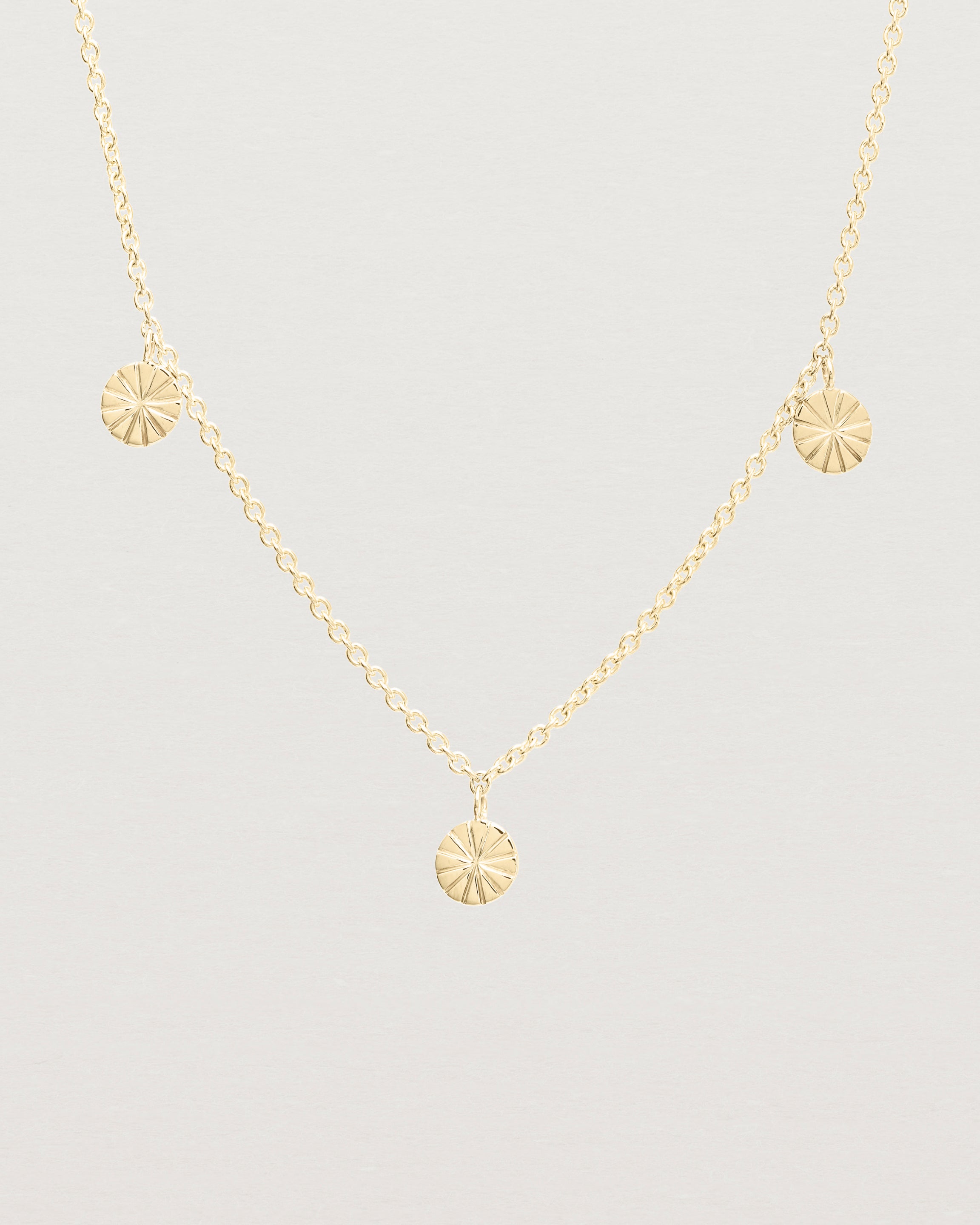 Close up view of the Jia Charm Necklace | Yellow Gold.