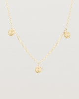 Close up view of the Jia Charm Necklace | Yellow Gold.