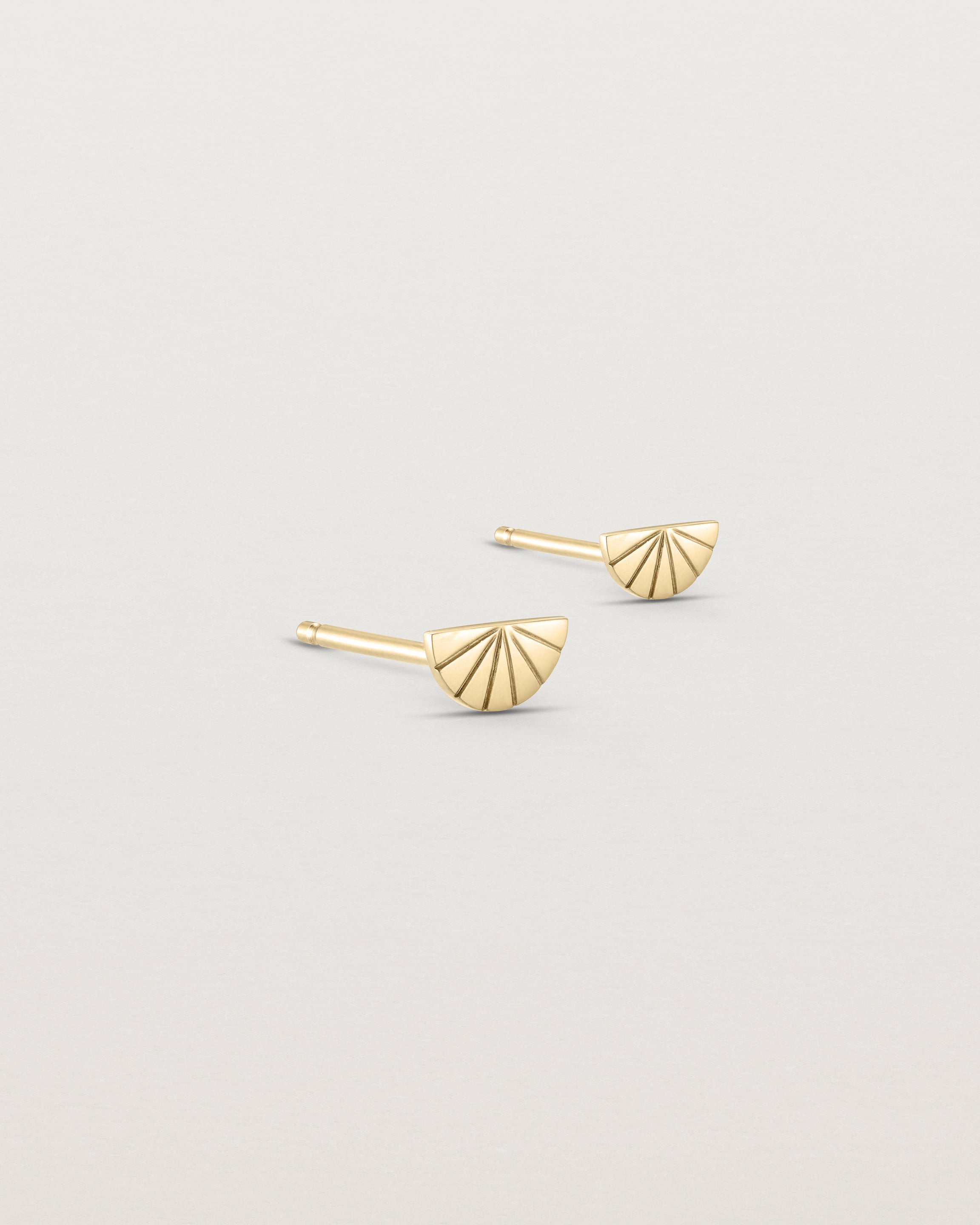 Angled view of the Jia Studs in yellow gold.