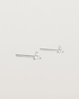 A pair of white gold studs with three small white diamonds.