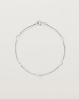 A silver chain bracelet with five gold arcs