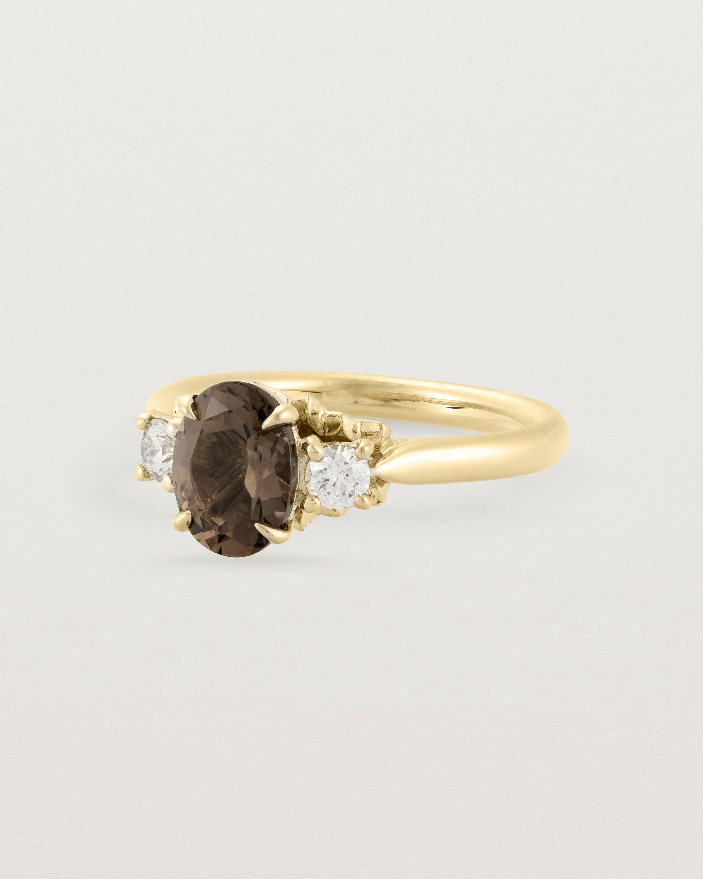 Angled view of the Laurel Oval Trio Ring | Smokey Quartz | Yellow Gold.