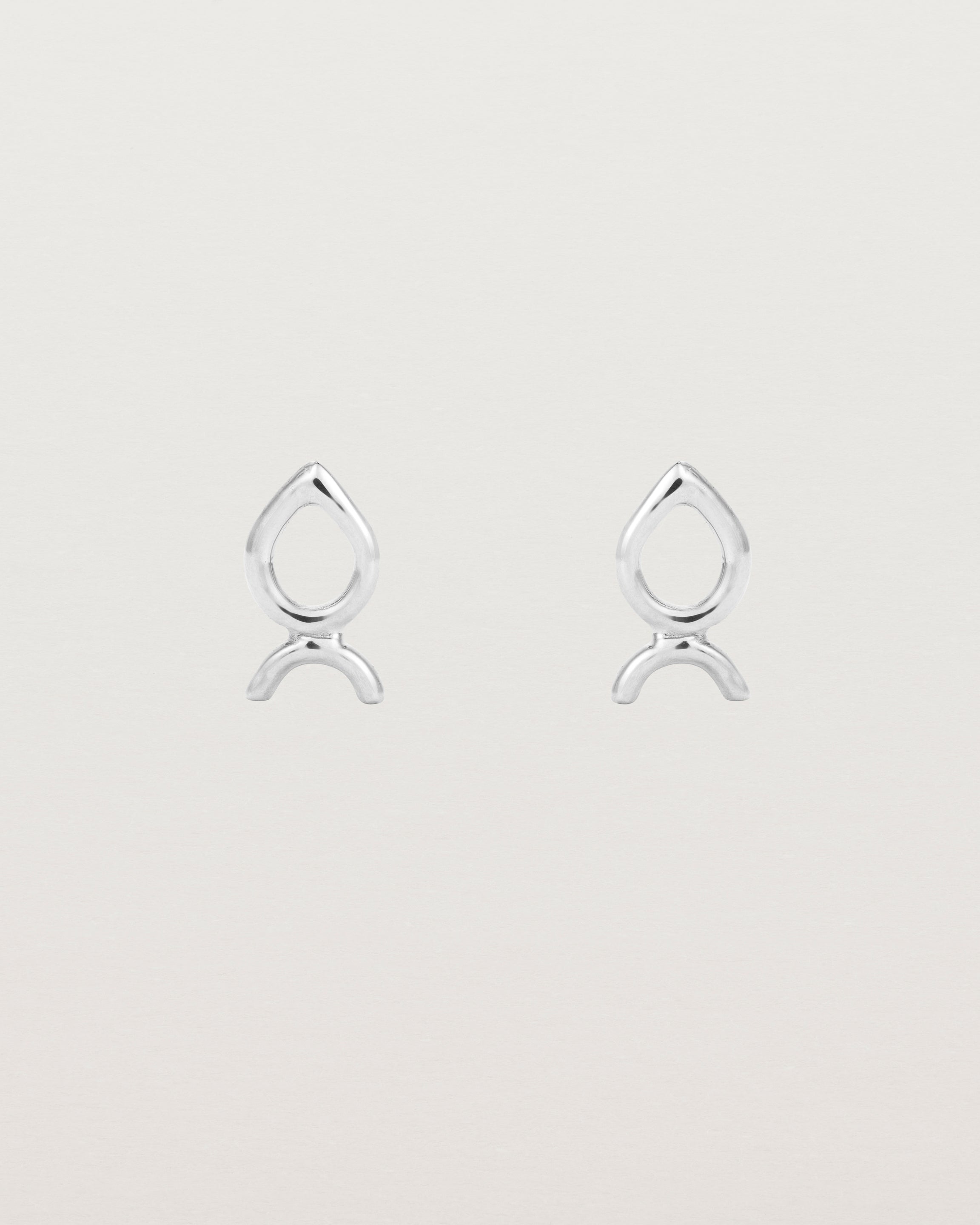 A small pair of sterling silver studs shaped like a tear drop