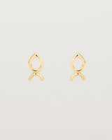 A small pair of yellow gold studs shaped like a tear drop