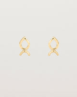 A small pair of yellow gold studs shaped like a tear drop