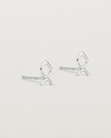 A small pair of sterling silver studs shaped like a tear drop