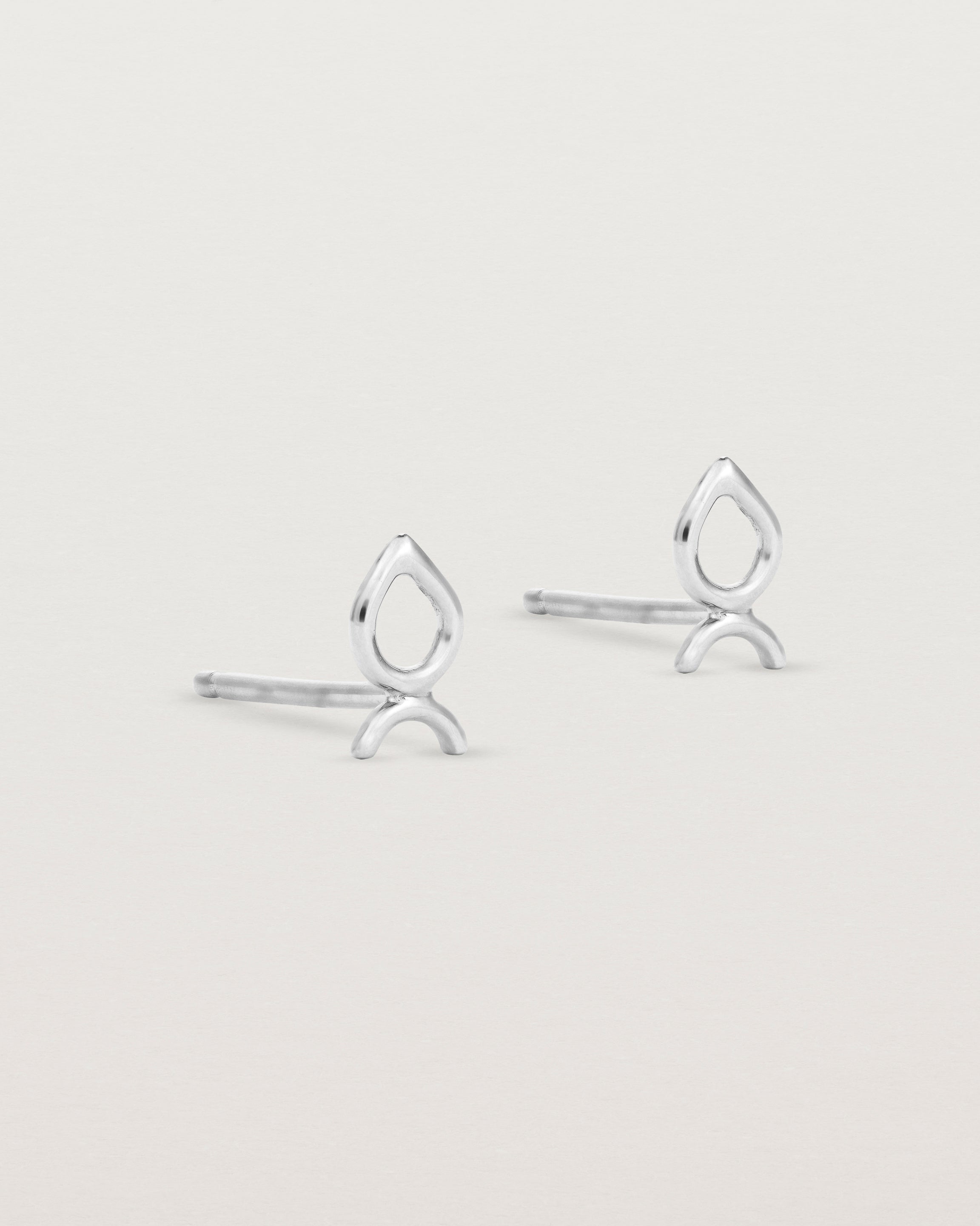 A small pair of sterling silver studs shaped like a tear drop