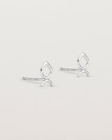 A small pair of sterling silver studs shaped like a tear drop