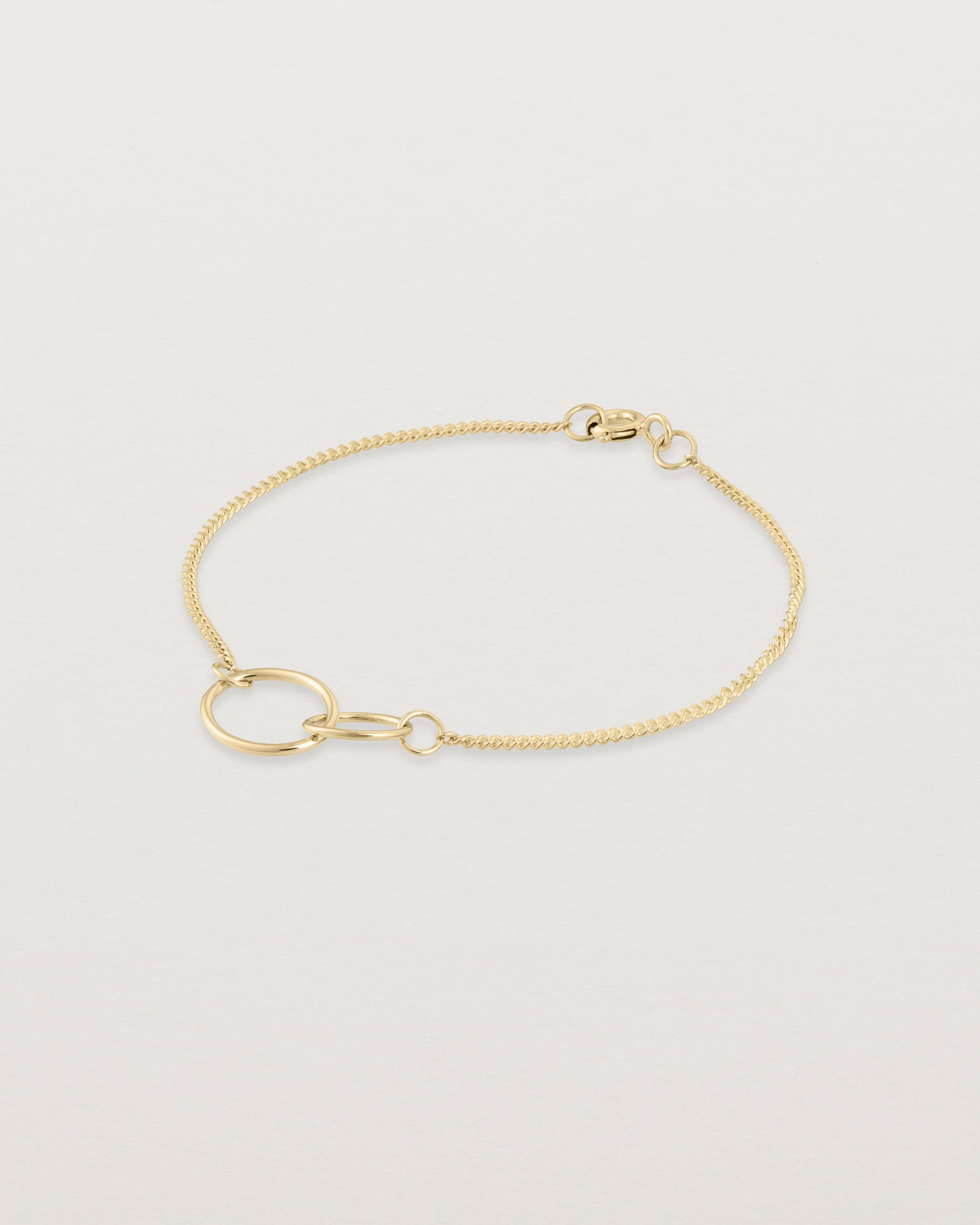 Side view of the loop through oval bracelet in yellow  gold