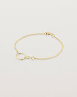 Side view of the loop through oval bracelet in yellow  gold