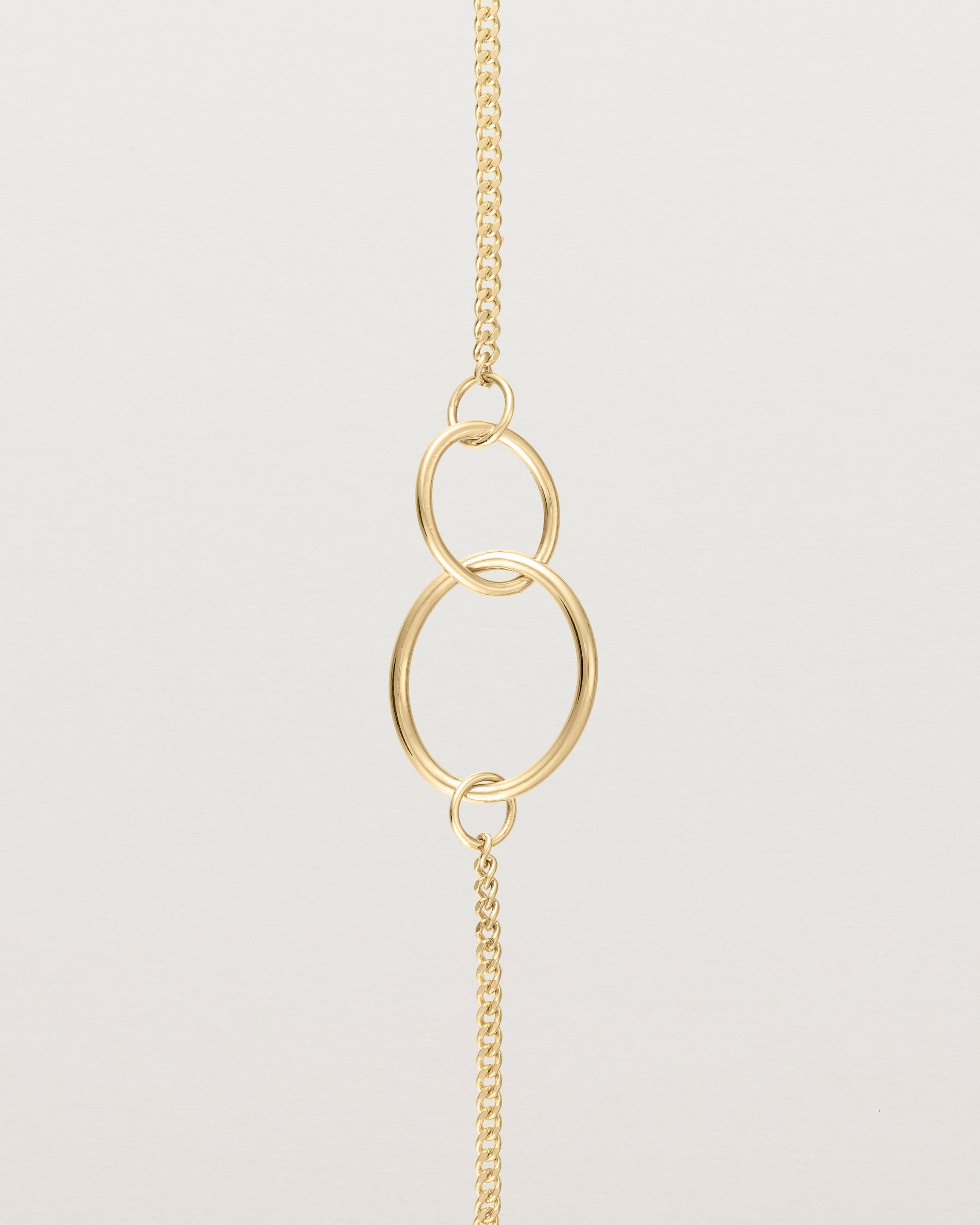 close up view of the loop through oval bracelet in yellow  gold