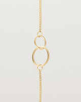 close up view of the loop through oval bracelet in yellow  gold