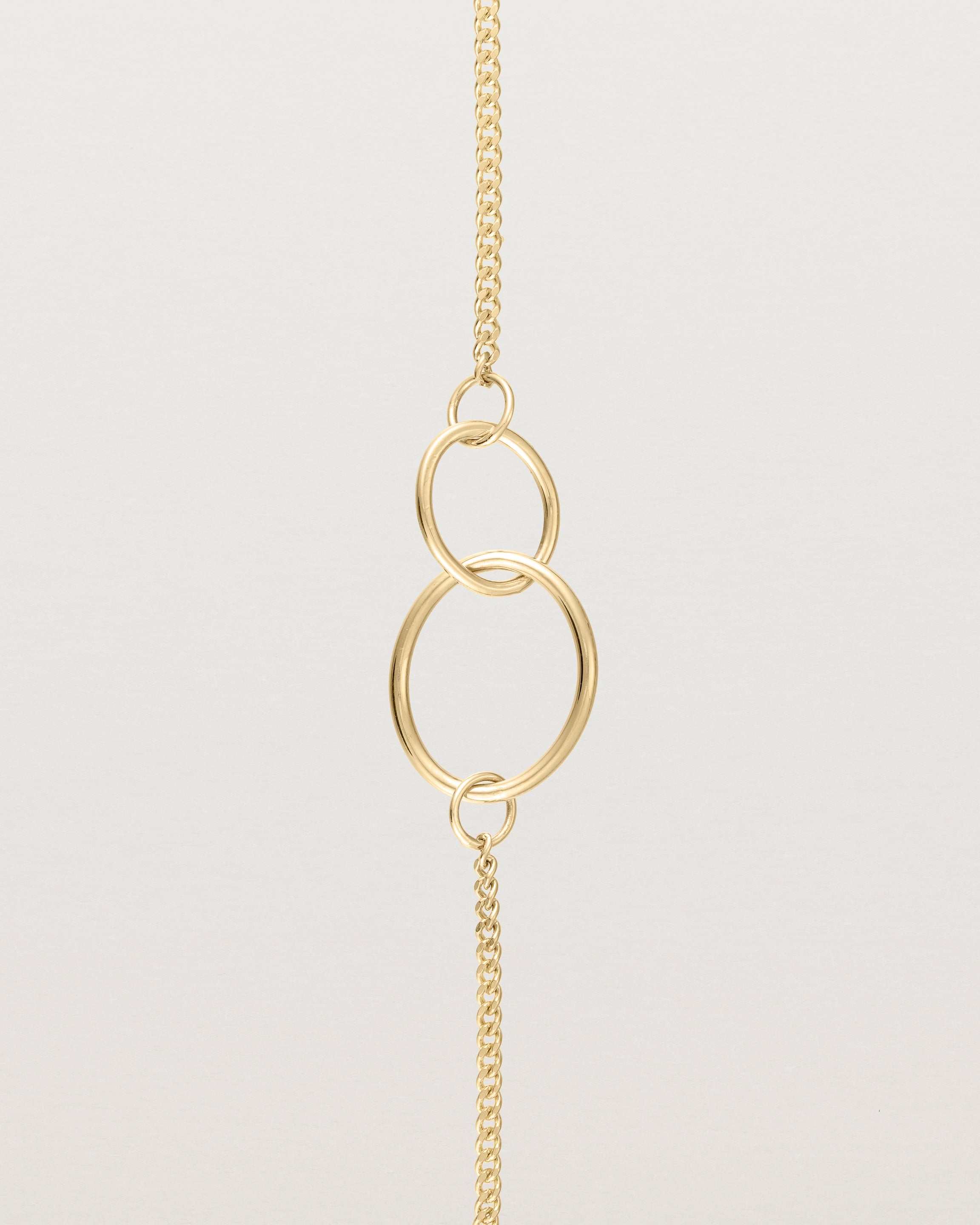 close up view of the loop through oval bracelet in yellow  gold