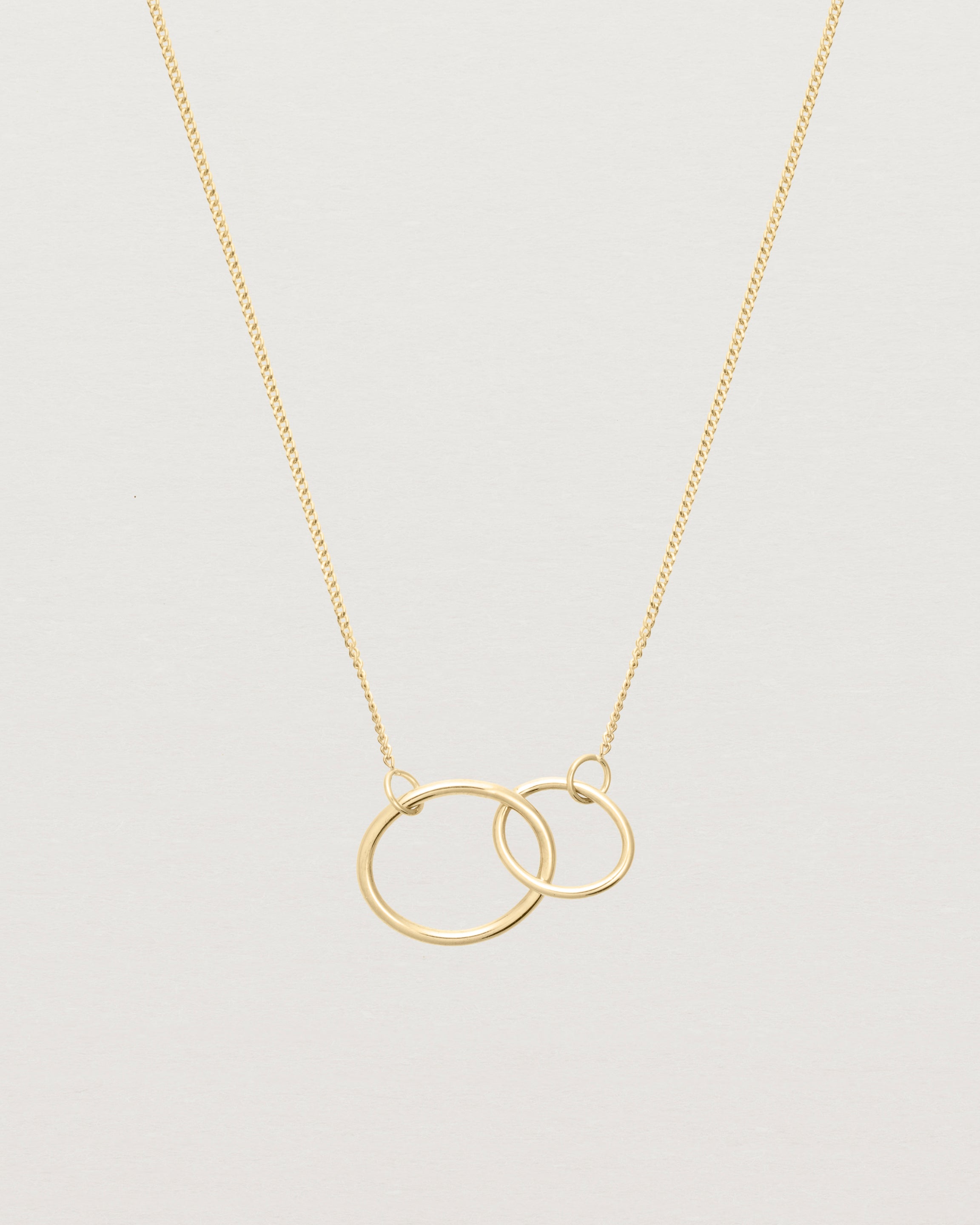two circles interlinking on a yellow gold necklace