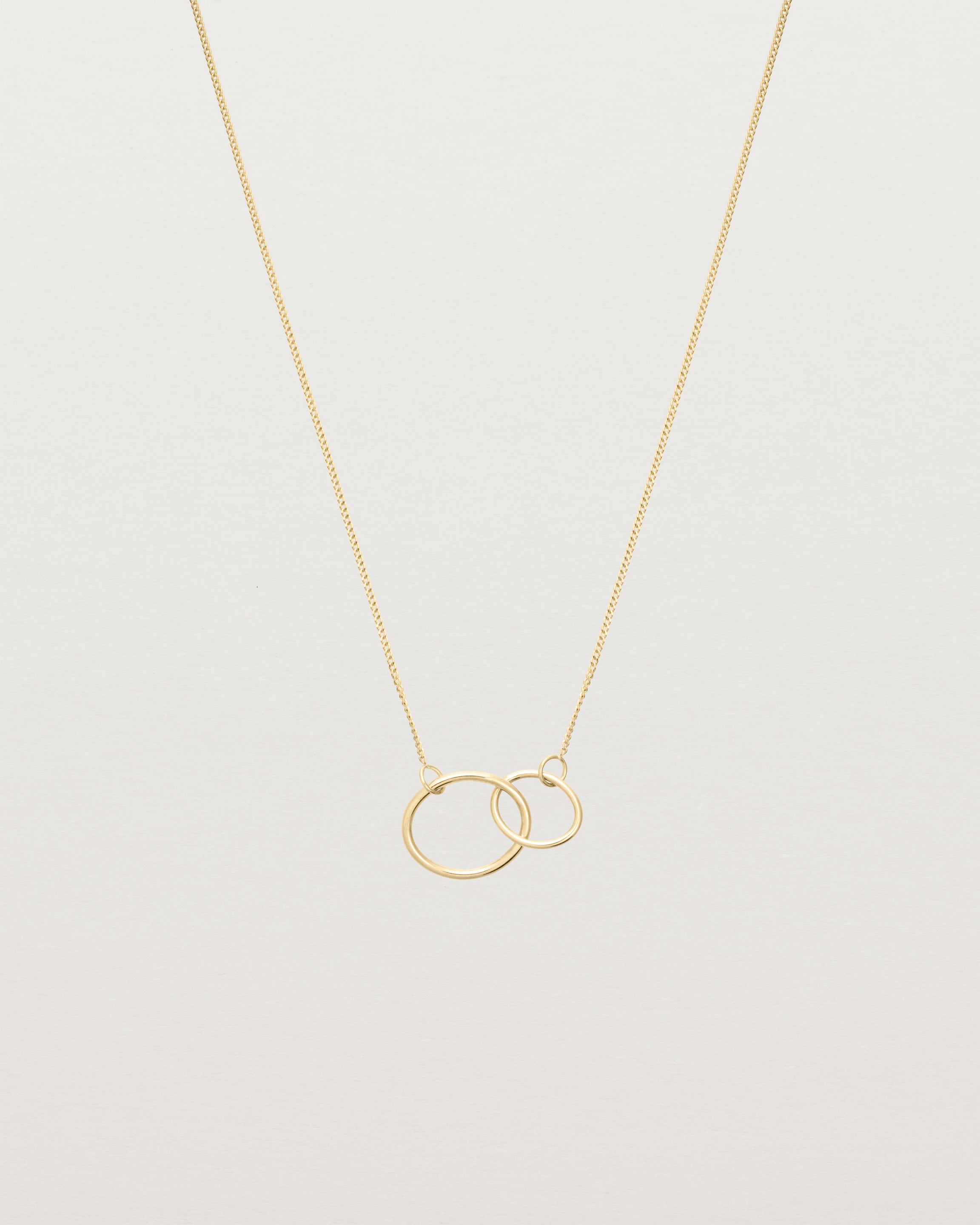 two circles interlinking on a yellow gold necklace
