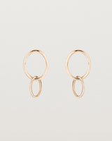 A pair of rose gold studs featuring two intertwined hanging ovals