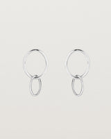 A pair of sterling silver studs featuring two intertwined hanging ovals
