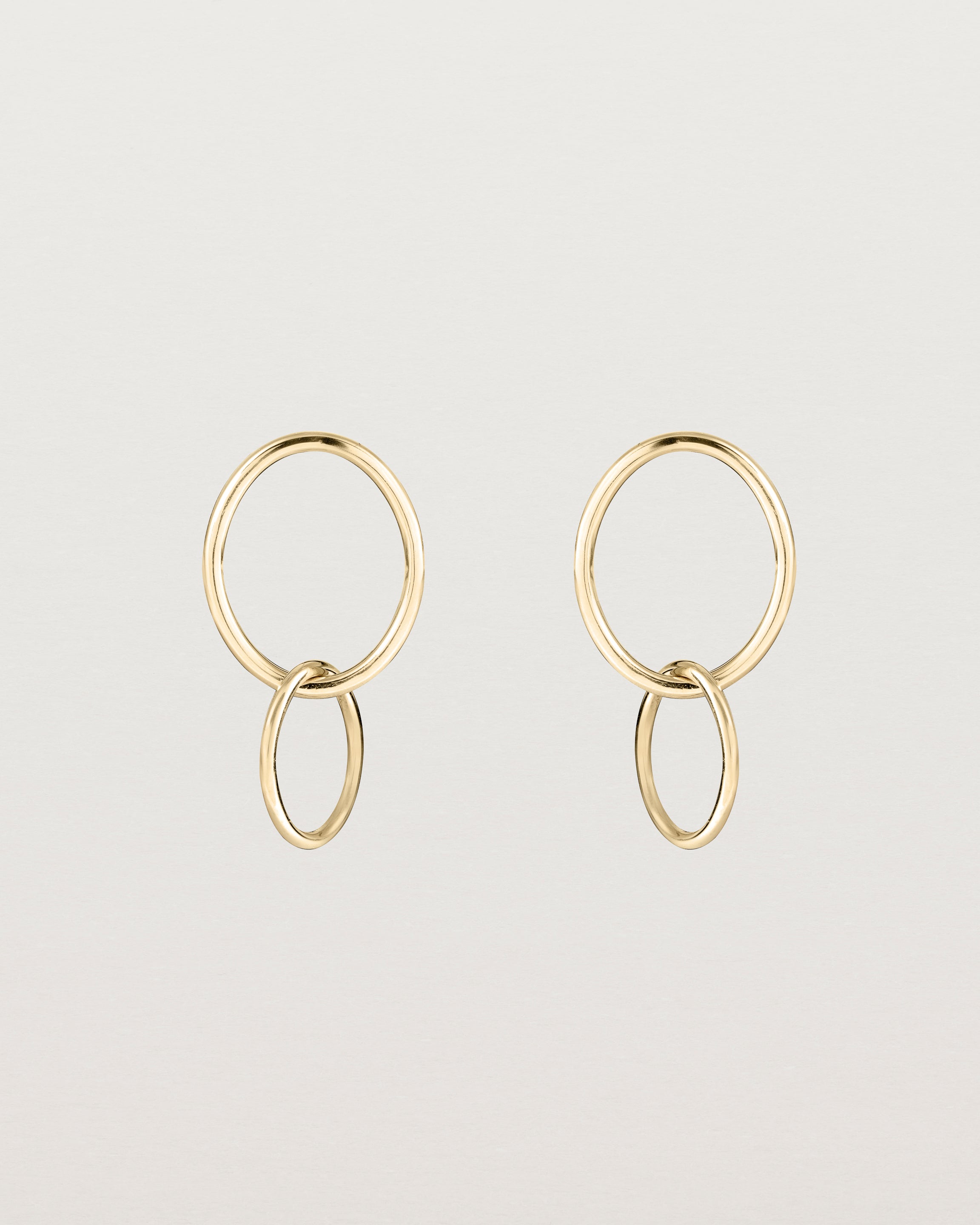 A pair of yellow gold studs featuring two intertwined hanging ovals