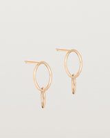 A pair of rose gold studs featuring two intertwined hanging ovals