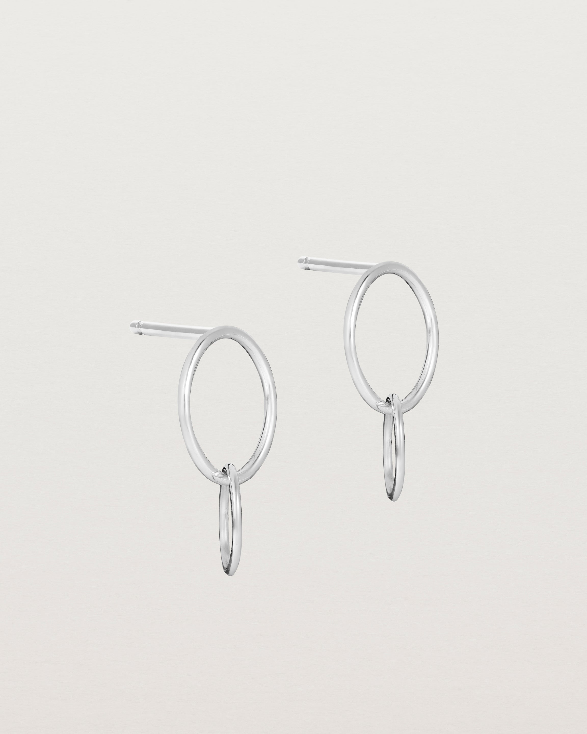 A pair of sterling silver studs featuring two intertwined hanging ovals