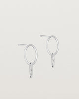 A pair of sterling silver studs featuring two intertwined hanging ovals