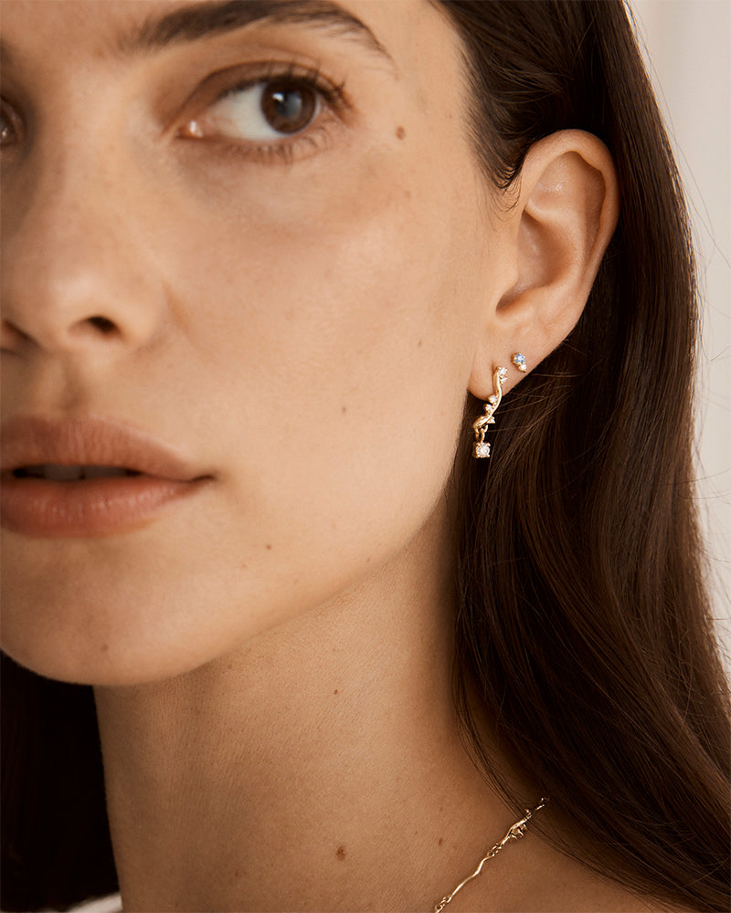 photo of model wearing lottie earrings with diamonds and ceylon sapphires 