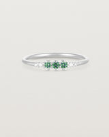 Front facing deep etched image of a white gold ring with alexandrite birthstones and diamonds.