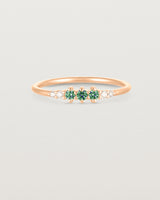 Front facing deep etched image of a rose gold ring with alexandrite birthstones and diamonds.