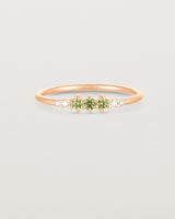 Front facing deep etched image of a rose gold ring with peridot birthstones and diamonds.
