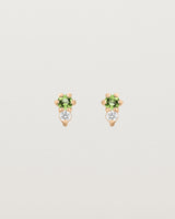 Front facing deep etched image of a pair of rose gold earrings with peridot birthstones and diamonds.