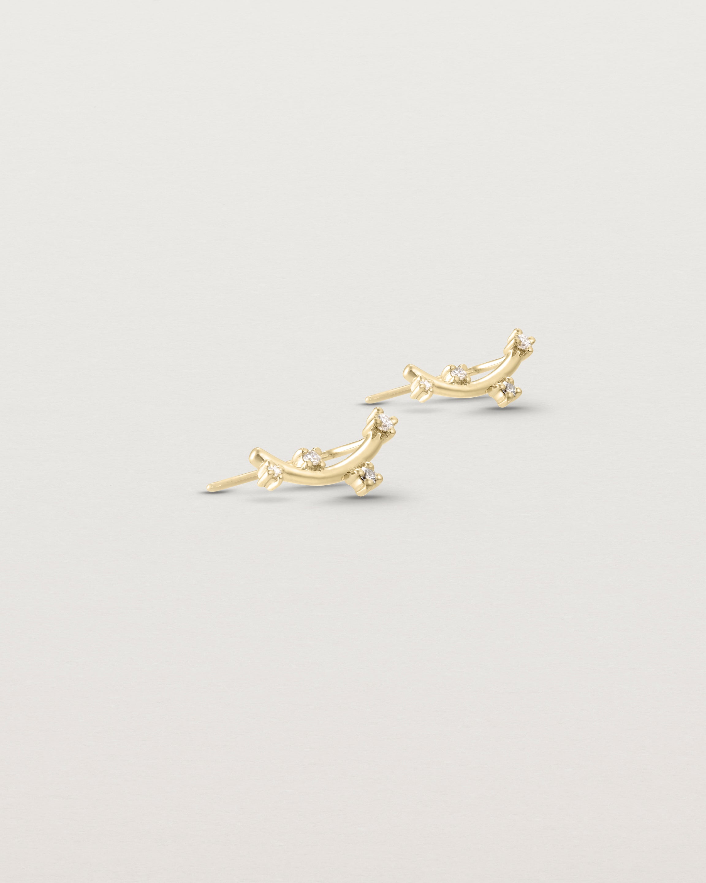 Angled view of the Lyra Earrings | Diamond in yellow gold.