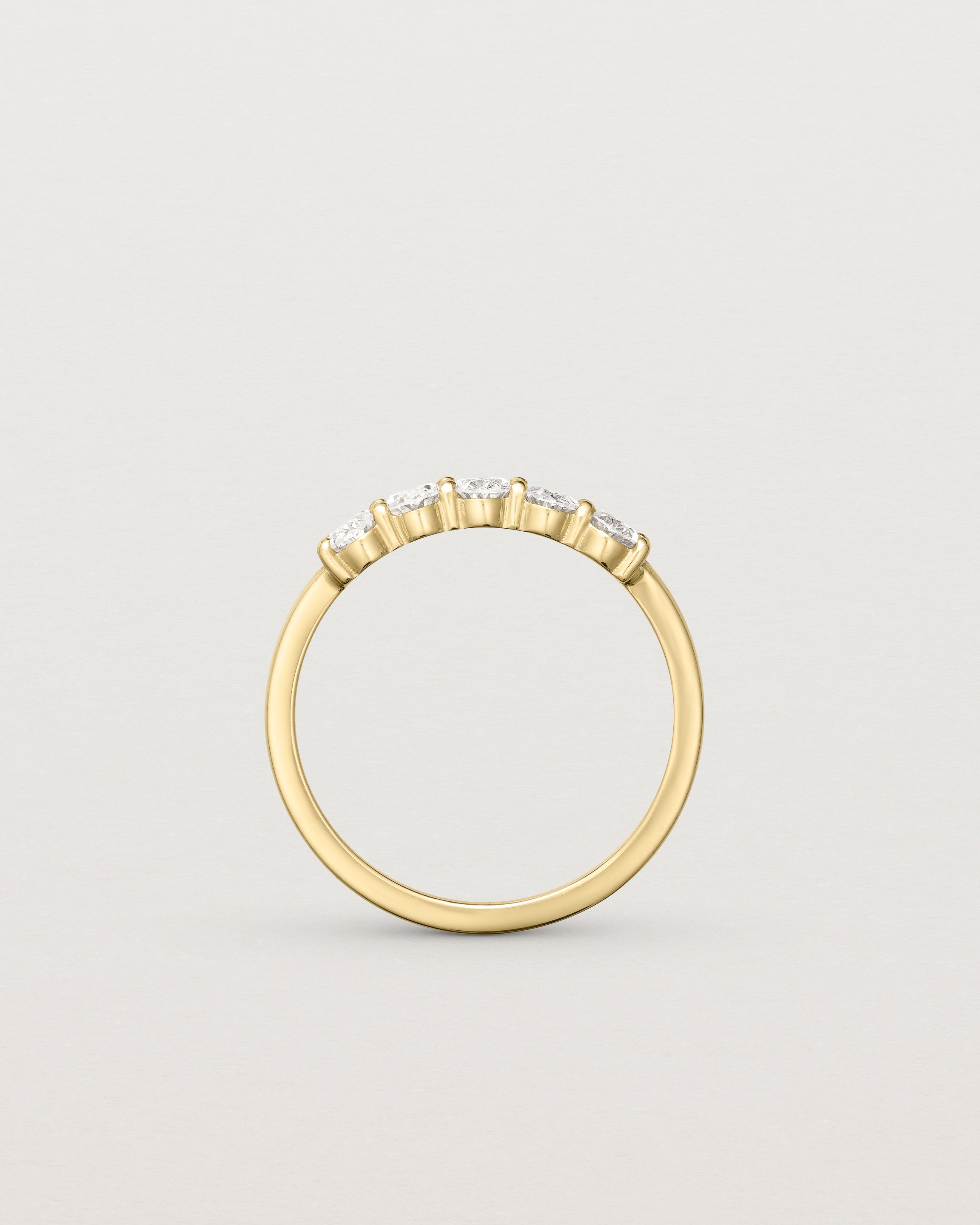 Standing deep etched image of a white gold wrap engagement ring with five oval diamonds.